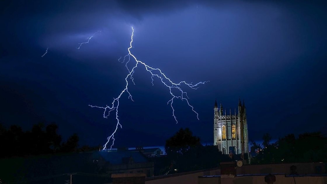 Lightning over a stone tower at night